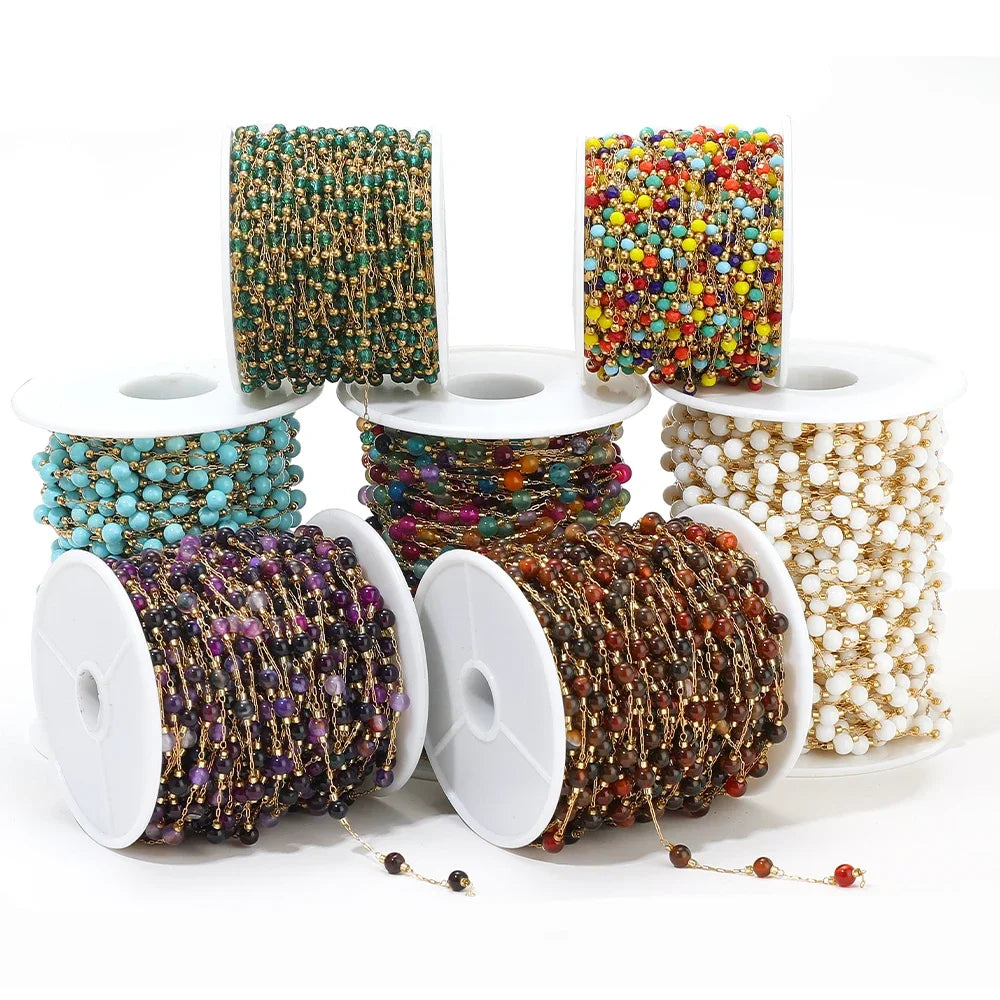 Assorted bead chain strands on spools with gold-tone links and multicolor beads