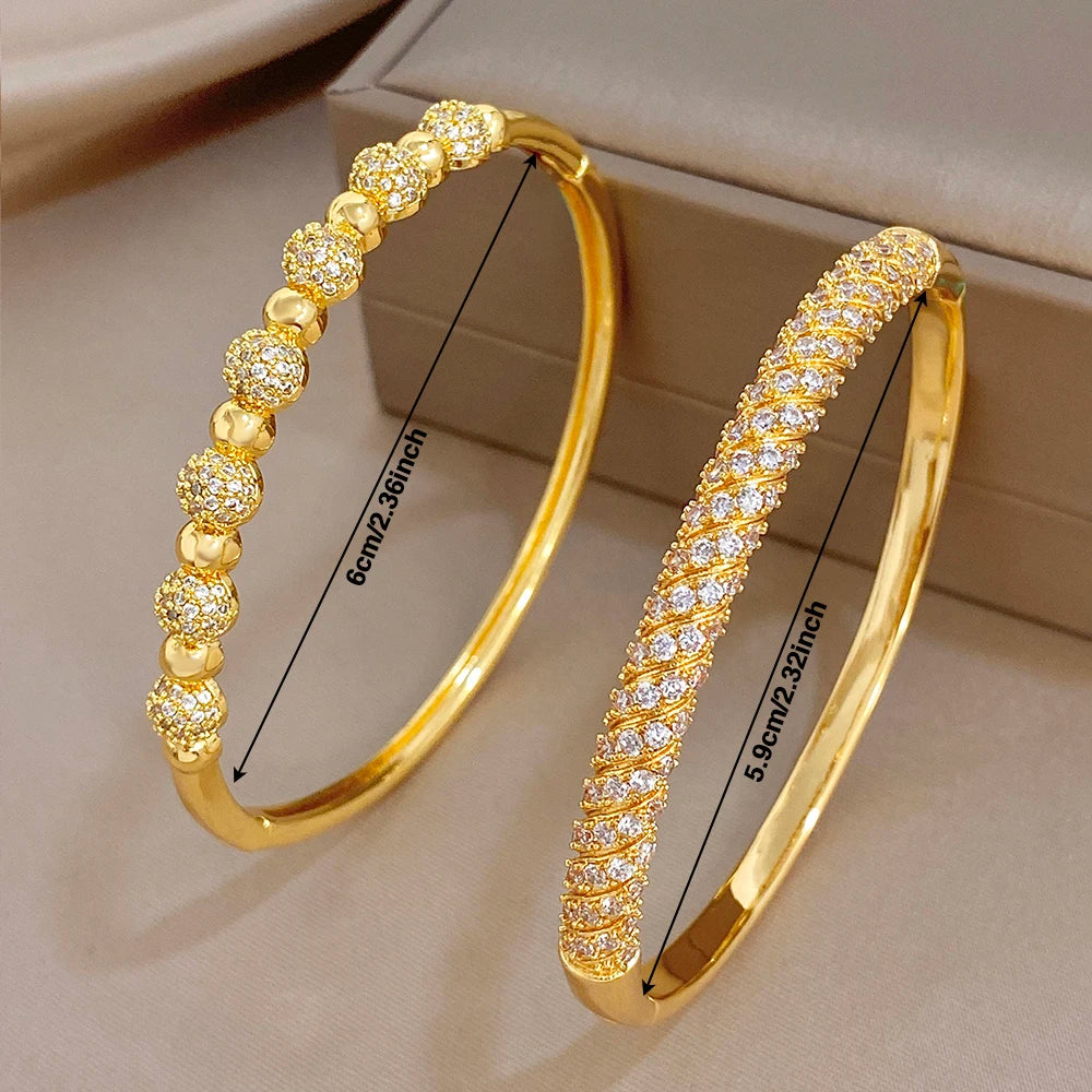 Gold-plated cuff bangles with zircon bead accents and twisted pavé detail