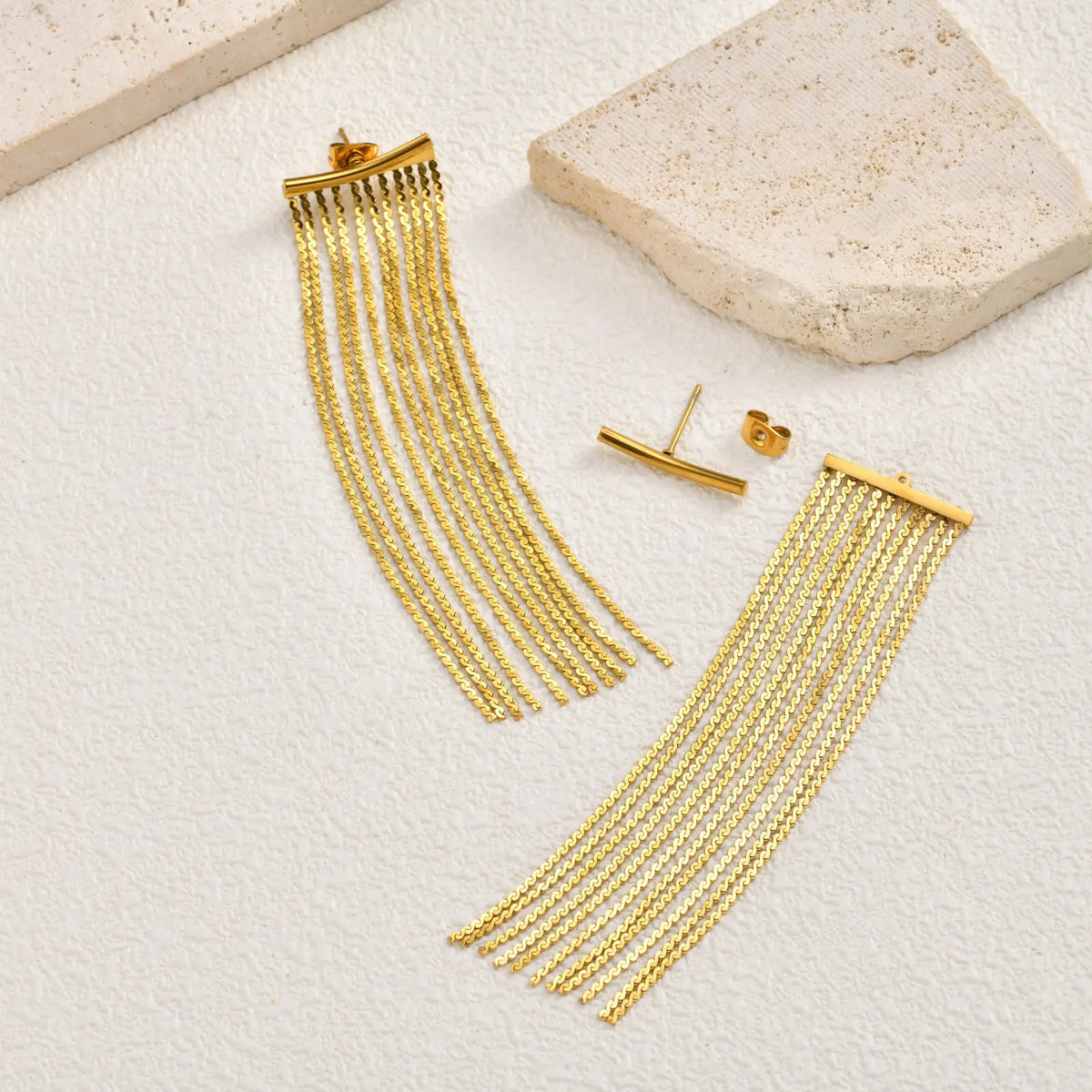 Gold long chain fringe tassel earrings with small bar studs nearby