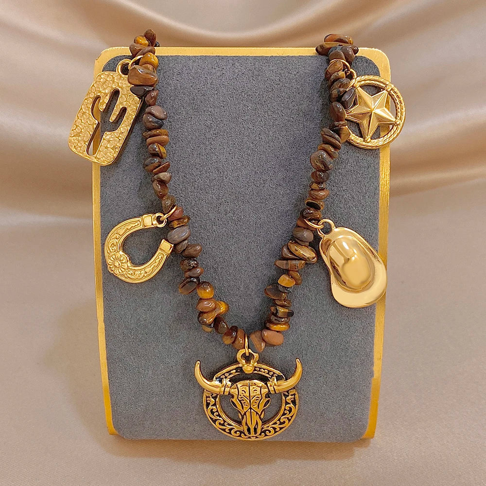 Gold-tone charm beaded necklace with bull head pendant, crescent, cactus, star and teardrop charms