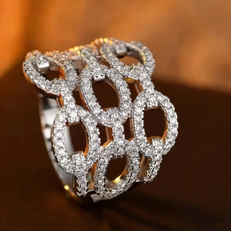 Silver-tone crystal cluster ring with large oval openwork link design