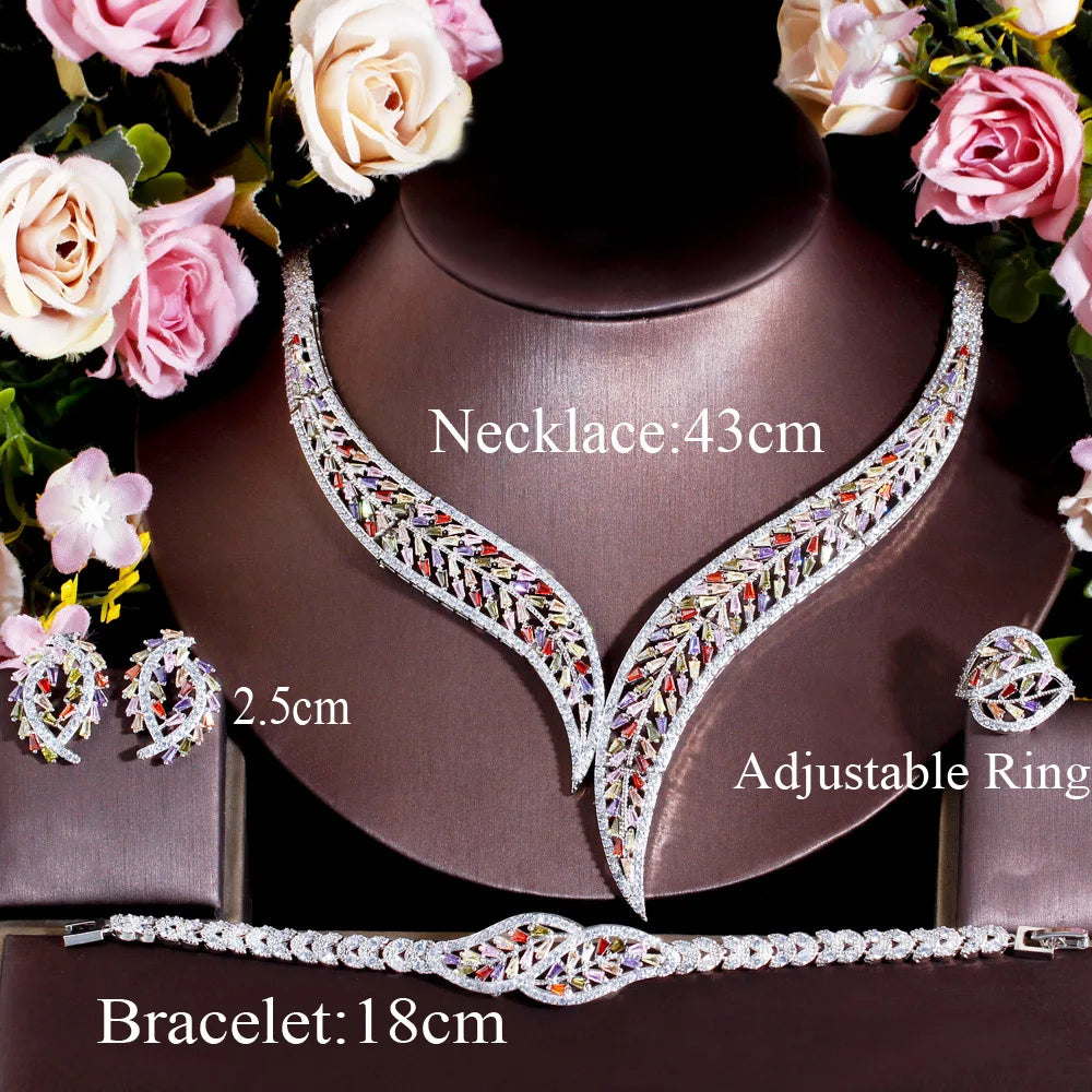 Multicolor CZ leaf bridal jewelry set on stand: necklace, bracelet, earrings, ring