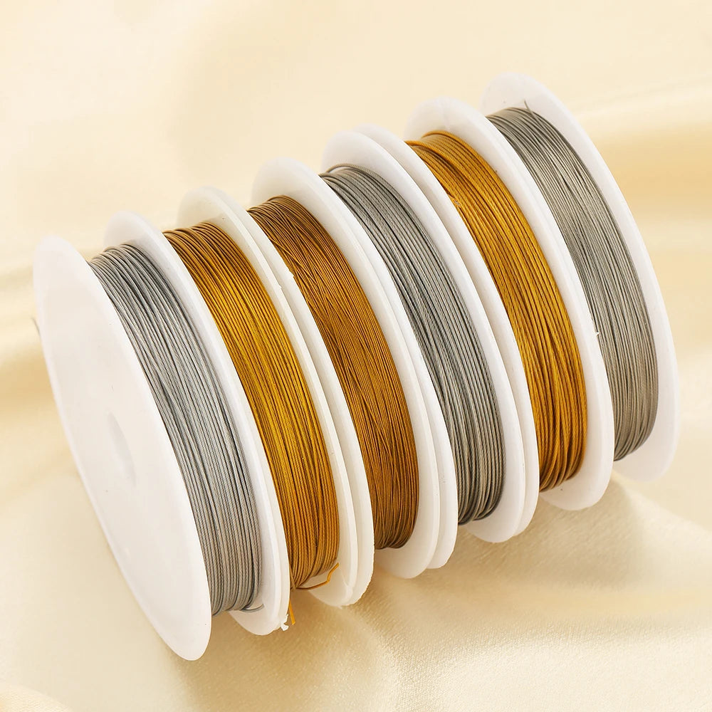 Stainless steel beading wire cords, multiple gold and steel spools lined up