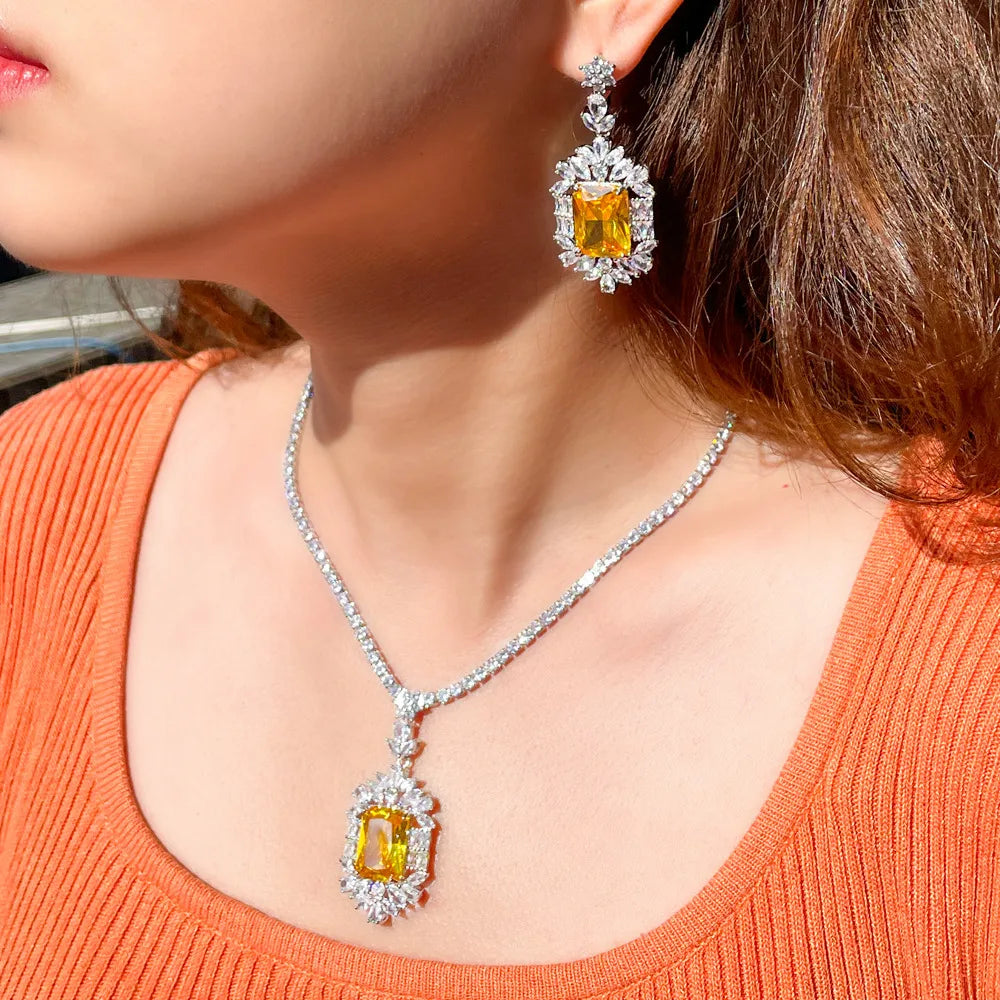 Cubic zirconia jewelry set with yellow square stones, silver-tone necklace and matching earrings