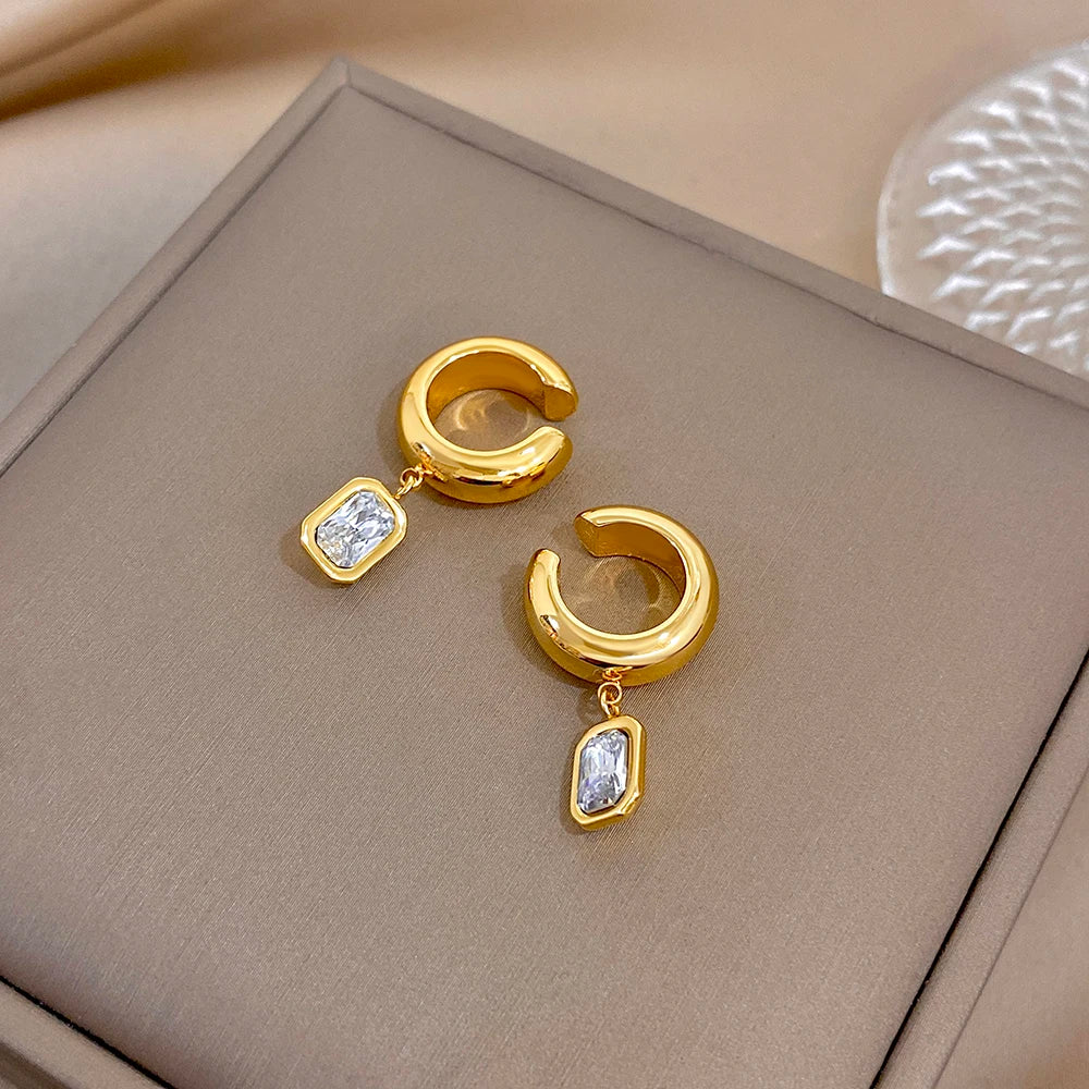 Gold-tone hoop ear clip earrings with dangling square zirconia charms