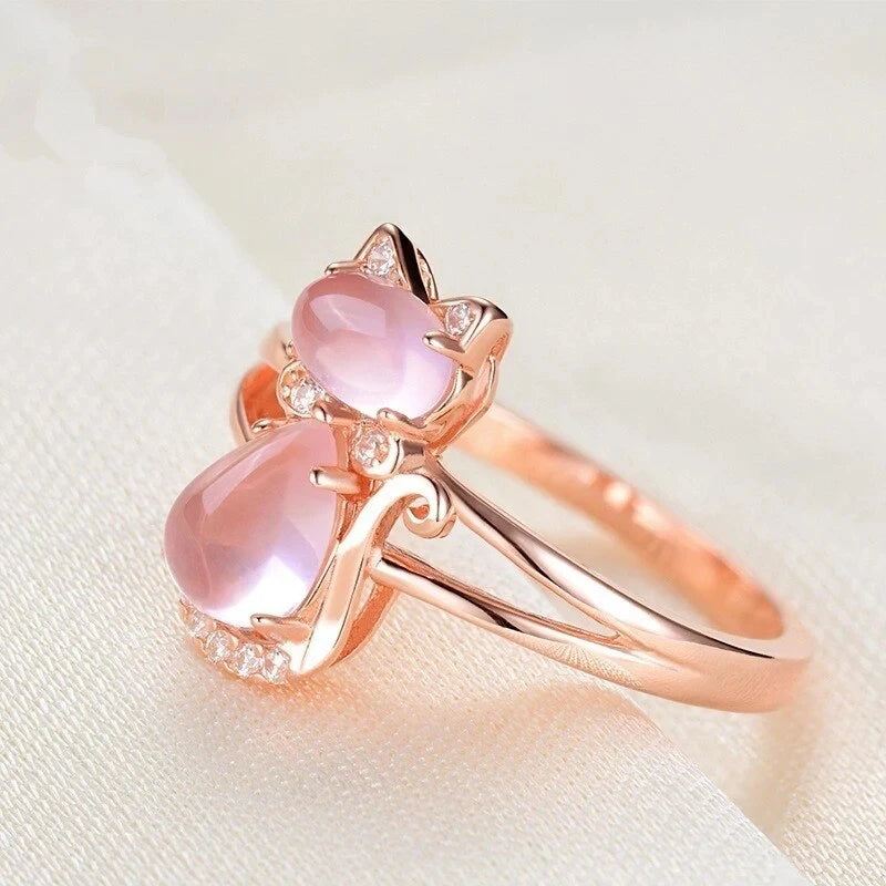 Rose gold cat ring angled view, pink teardrop stone with small clear stones