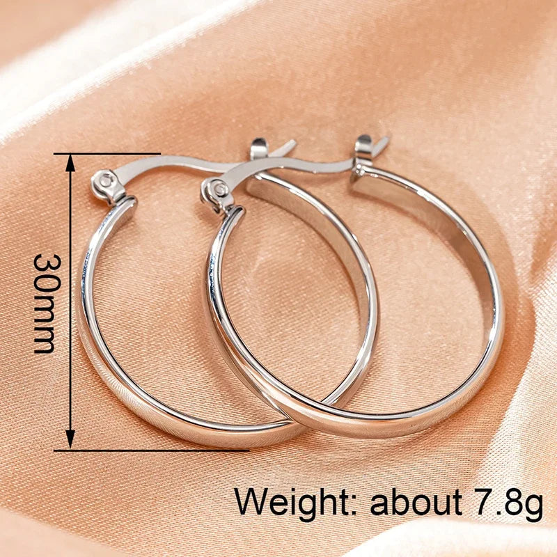 Silver-tone stainless steel hoop earrings, hinged round hoops close-up