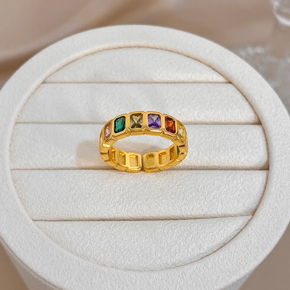Gold-tone band ring with colorful rectangular bezel-set stones and central row