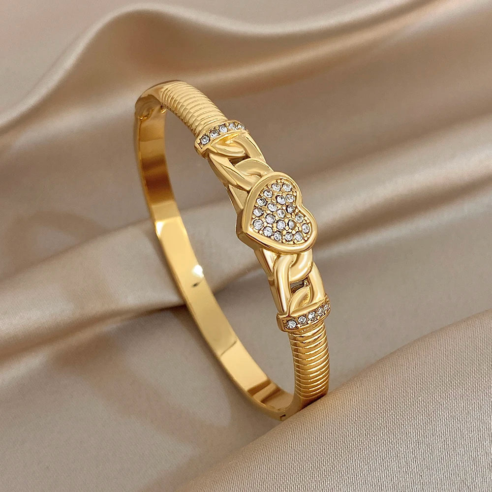 Gold-plated stainless steel cuff bangle with zircon heart and twisted knot design