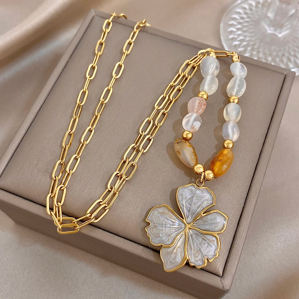 Gold plated necklace with white and amber beads and large white enamel flower pendant
