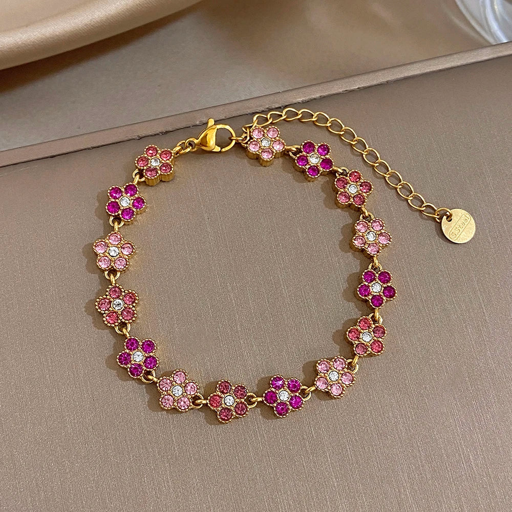 Gold-tone flower zircon bead bracelet with pink and fuchsia stones, chain clasp