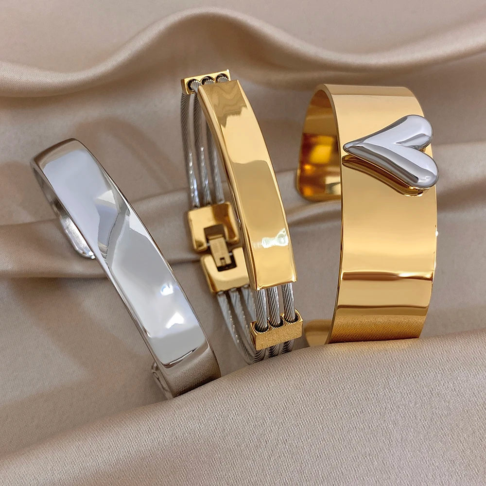 Gold and silver glossy chunky cuff bangles with geometric clasp details, stacked look