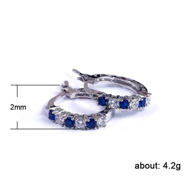 Silver circle hoop earrings with blue and clear stone row