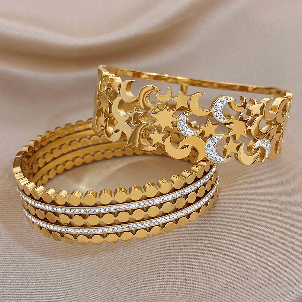 Gold-tone wide cuff bangle and matching layered band with star-moon crystal accents
