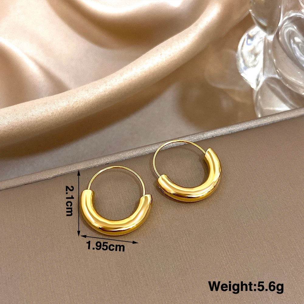 Gold-tone hoop earrings with chunky curved fronts, marked 2.1 by 1.95 cm