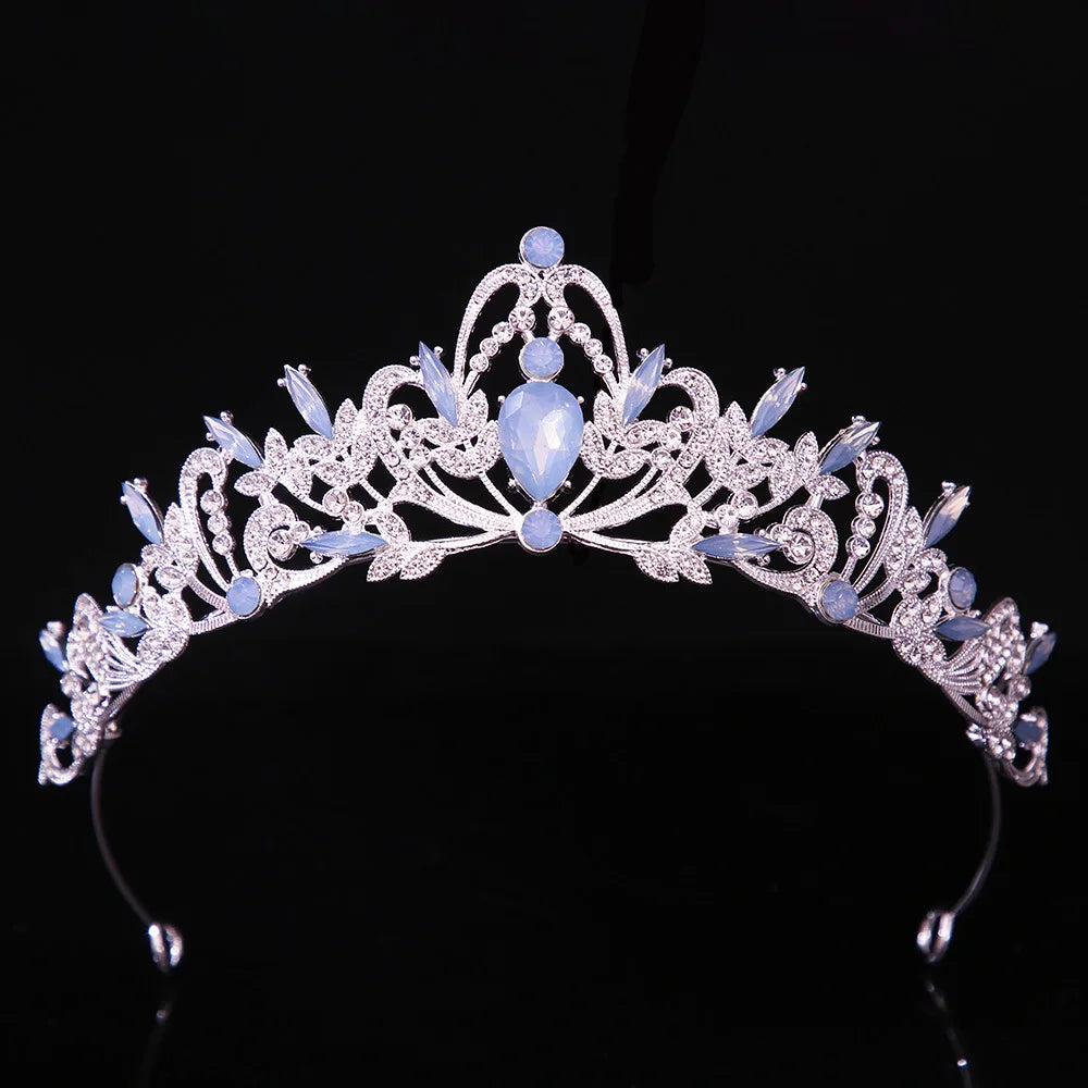 Jeweled bridal tiara crown with light blue oval center gemstone and lavender accents