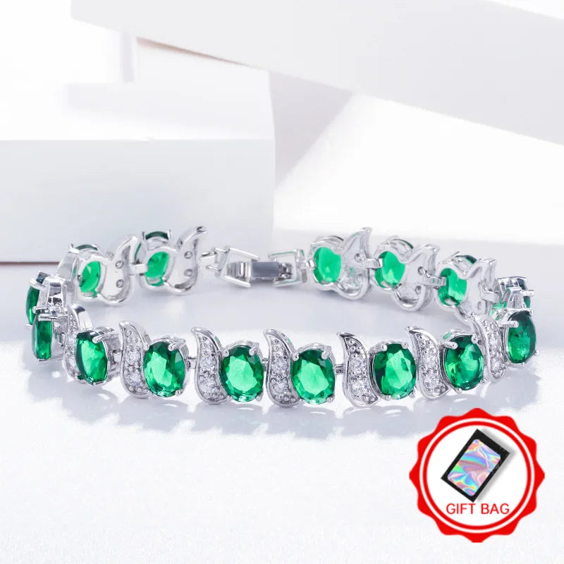 Green oval crystal tennis bracelet with silver-tone leaf accents and clasp