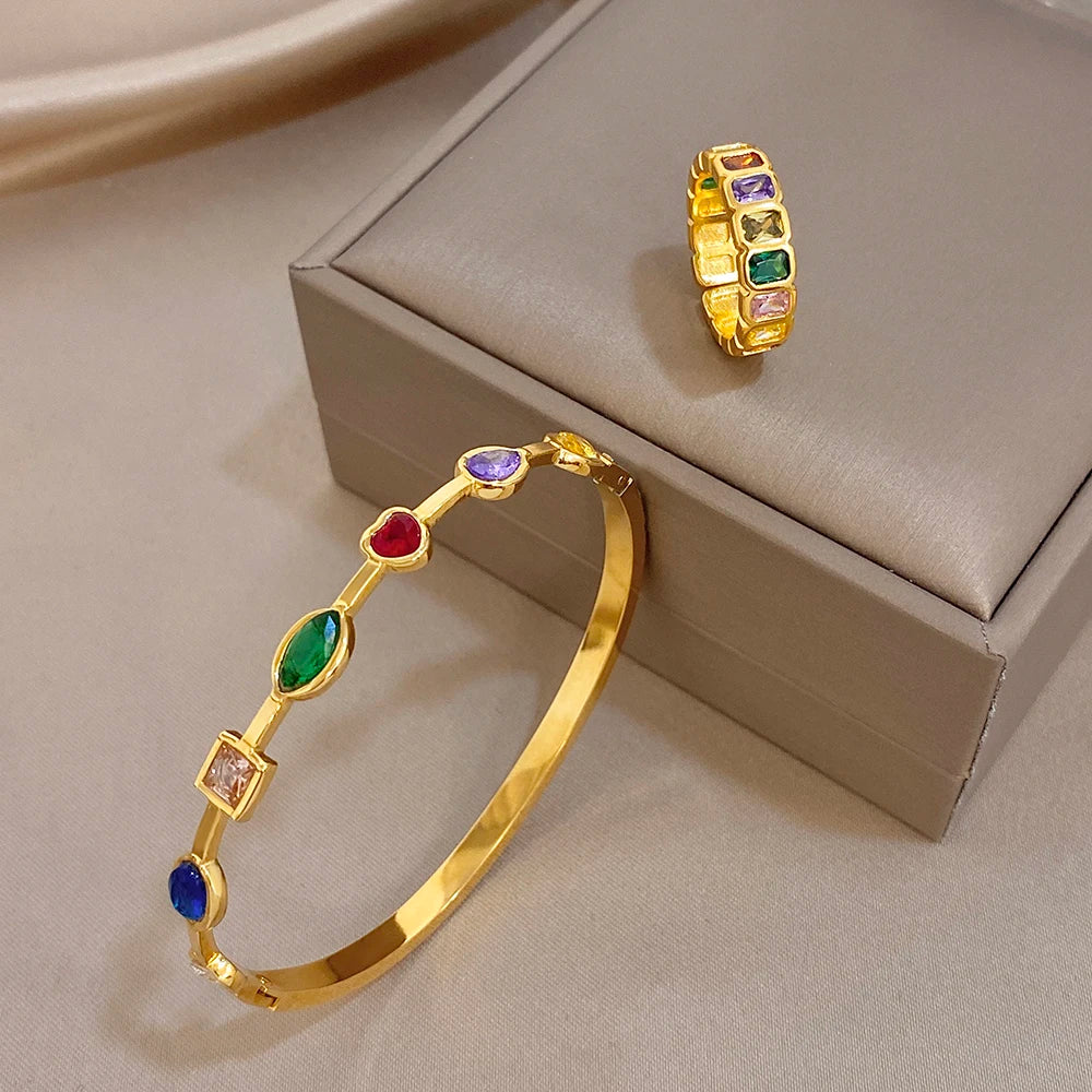 Gold-tone bangle bracelet with multicolor stones and a matching square-stone band ring