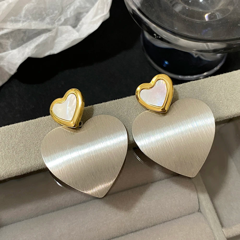 Silver-tone heart drop earrings with brushed finish and pearly heart studs
