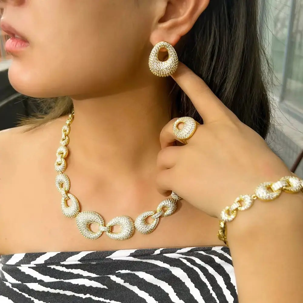 Gold-tone zirconia chain link necklace with hoop earrings and matching bracelet