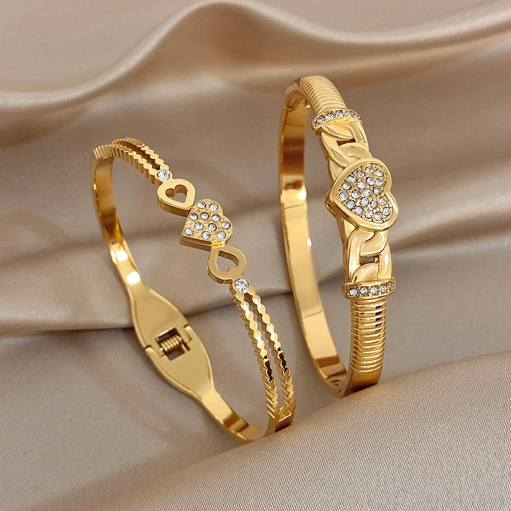 Gold-tone heart charm twisted knot cuff bangle bracelet with clear rhinestone details