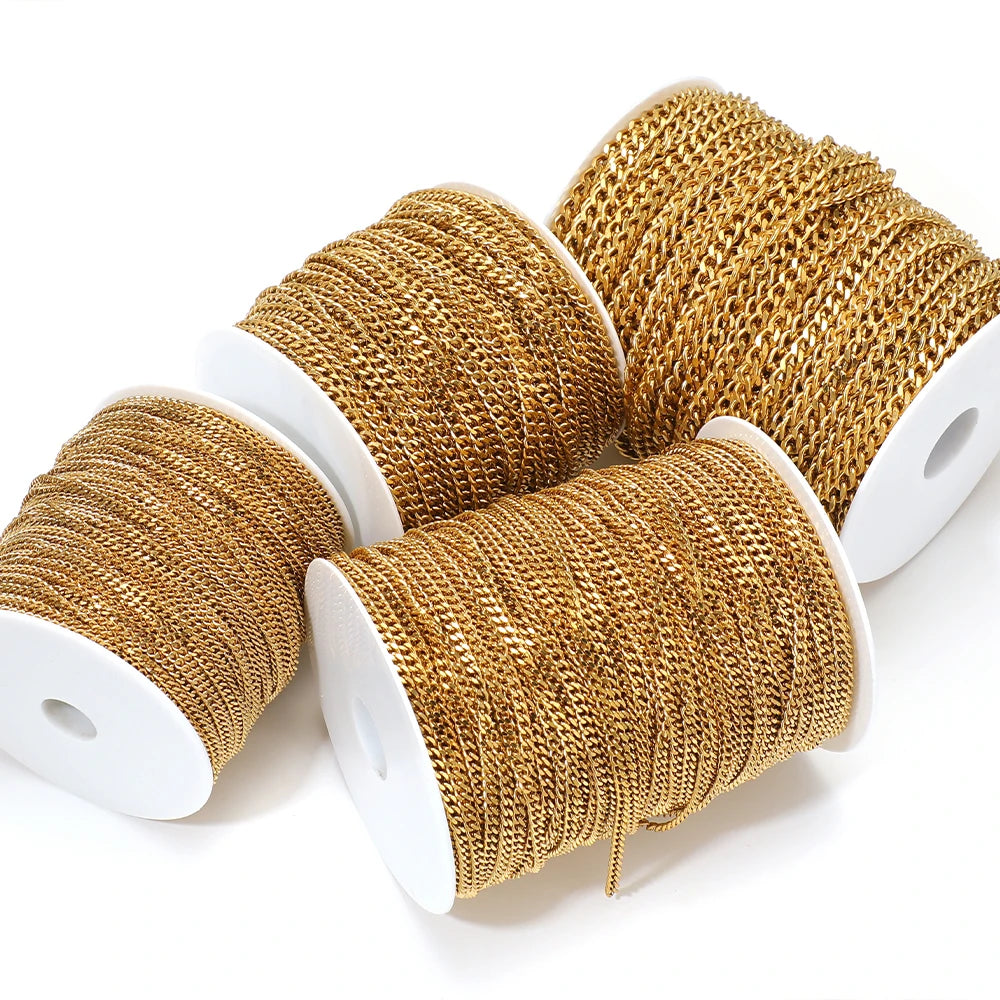 Gold-plated stainless steel Cuban link chain rolls, detailed view on white spools