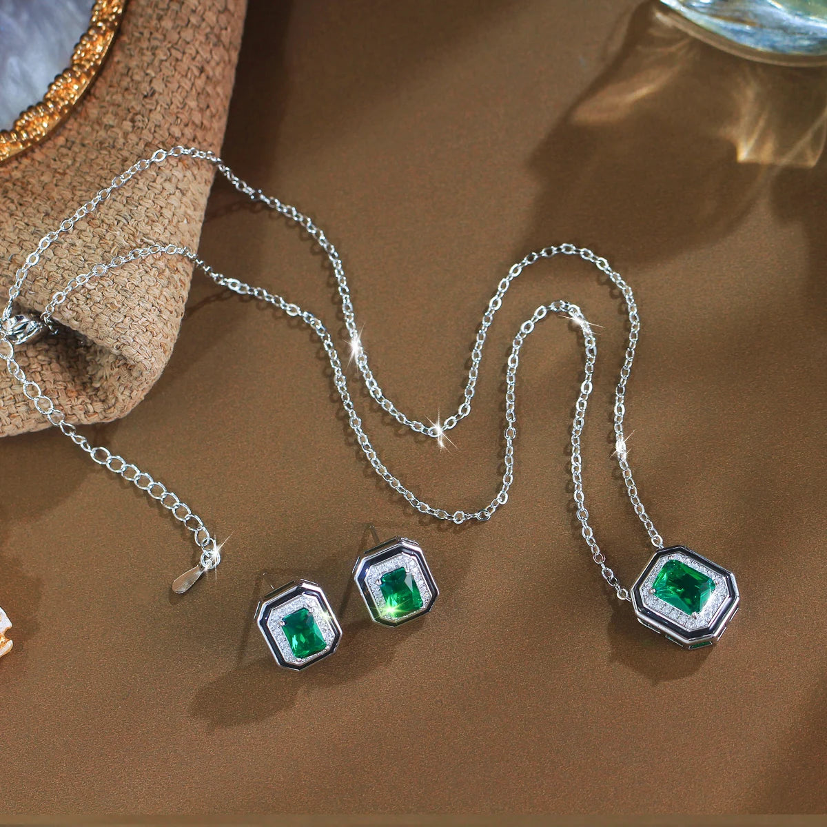 Silver-tone necklace and stud earrings set with rectangular green crystals and clear stone borders