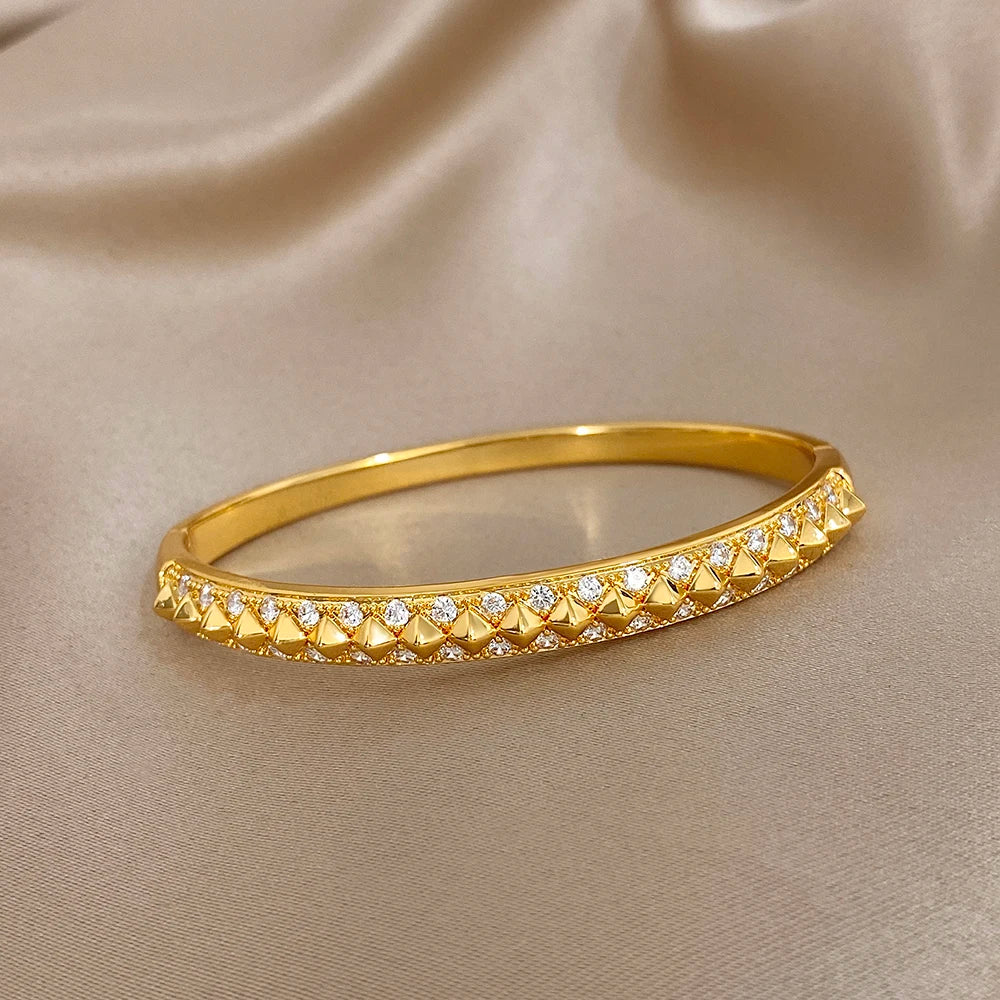 Gold-plated geometric zirconia rivet cuff bangle, oval profile with stone band
