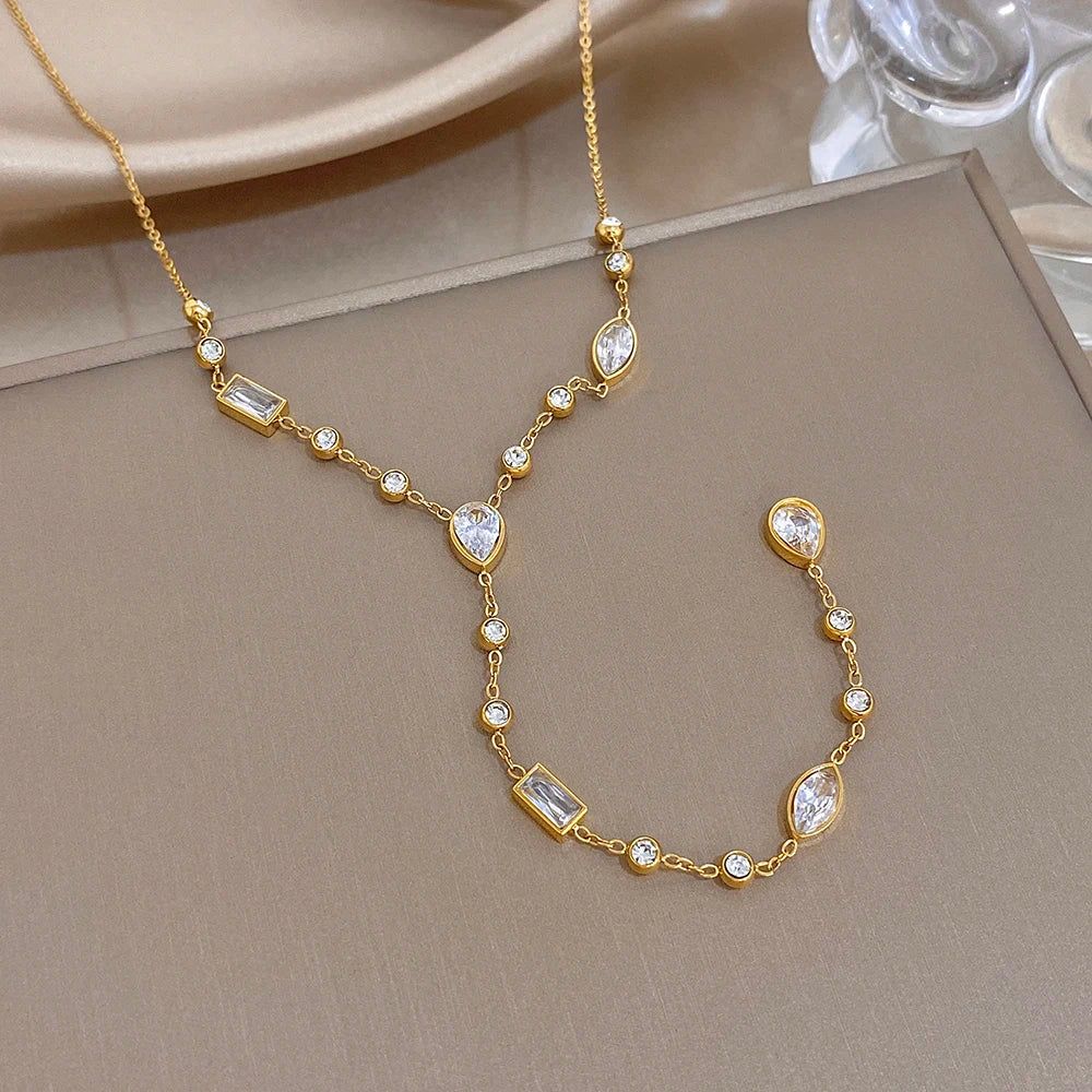 Gold-tone Y choker necklace with oval crystal drops and geometric crystal bars