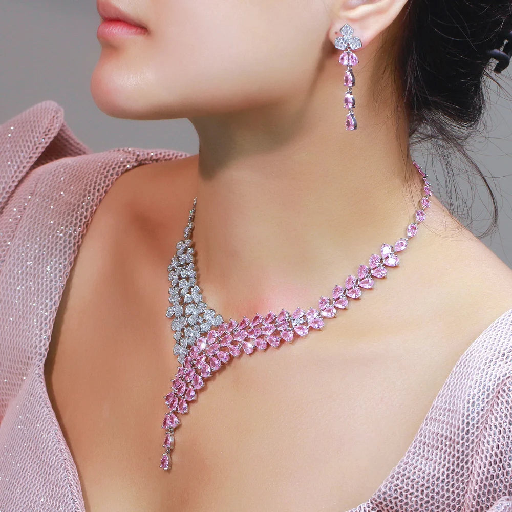 Pink and clear cubic zirconia necklace and drop earring modeled on a wearer