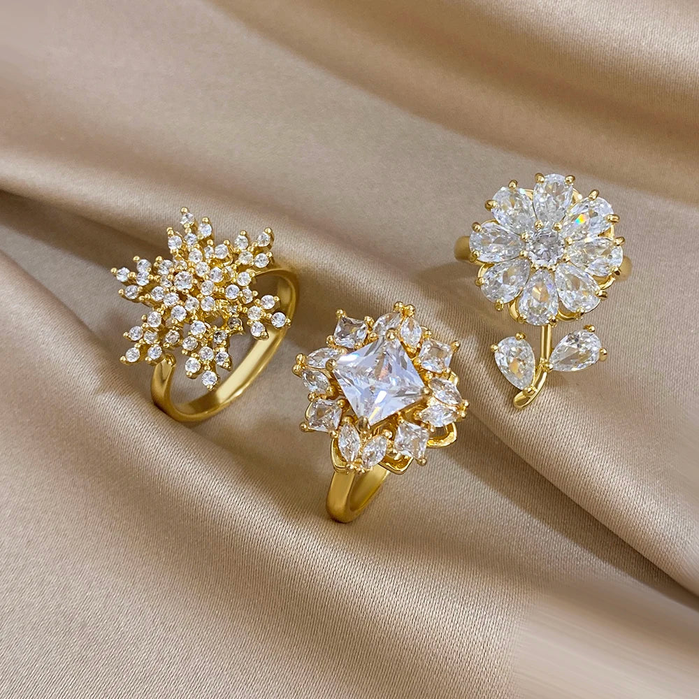 Gold-plated copper flower zirconia rings with clear, pink, and snowflake designs