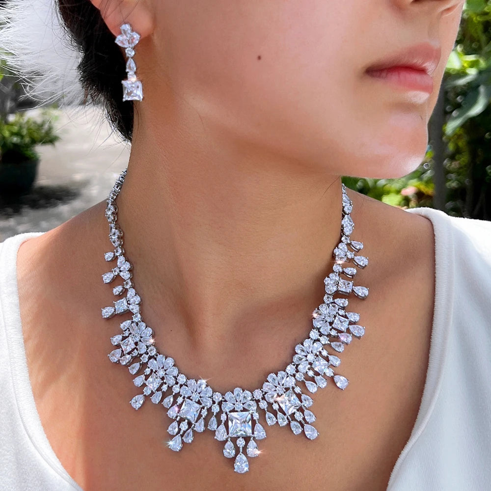 Cubic zirconia necklace and drop earrings set on model, silver-tone sparkle.