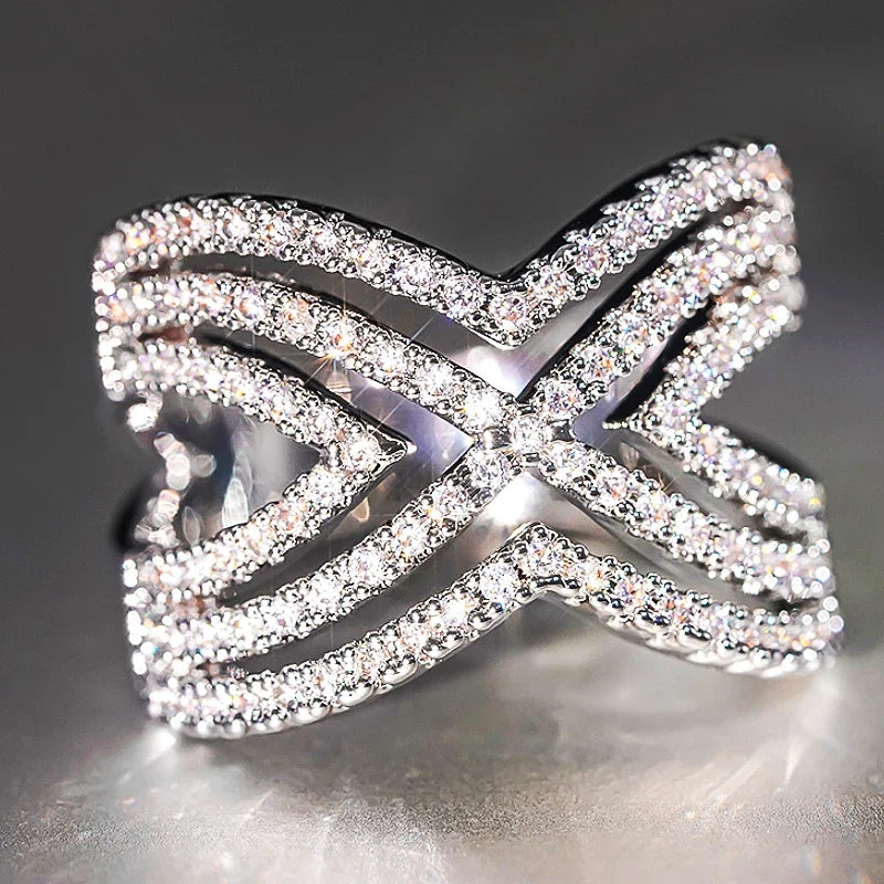 Sparkling rhinestone openwork cross ring with bow-like X motif, silver tone