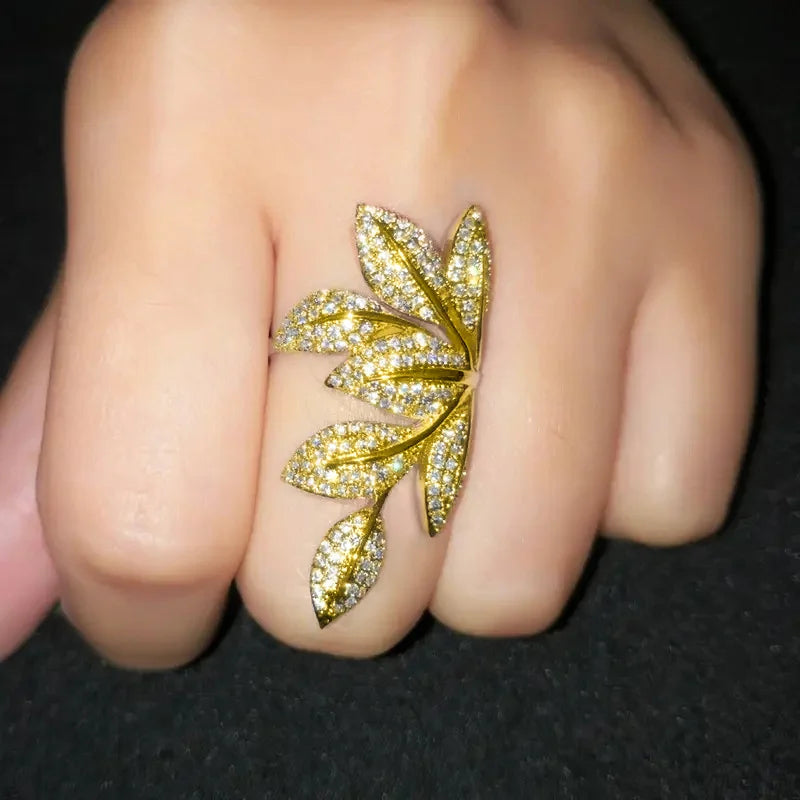 Gold-tone leaf cubic zirconia ring on finger