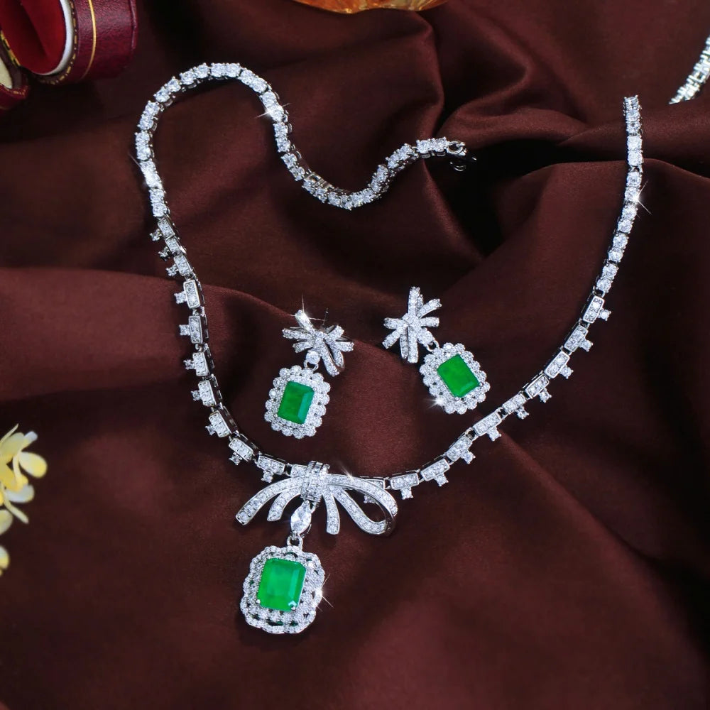 Green CZ bow necklace with rectangle green drop accents and matching dangle earrings