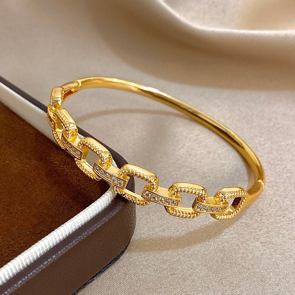 Gold-tone geometric cuff bracelet with square links and clear zircon details