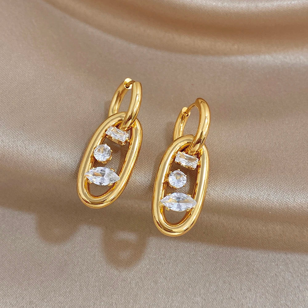 Gold-plated hoop earrings with three zircon stones per drop