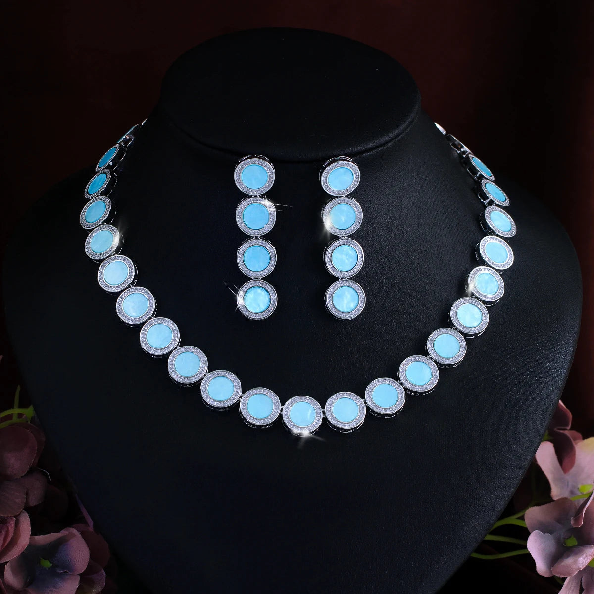 Blue oval link necklace with matching drop earrings, silver-tone settings on bust