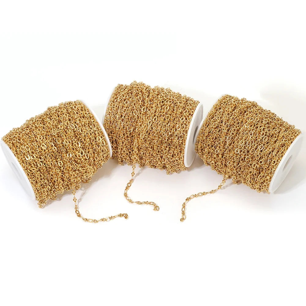 Gold embossed oval link chain bulk on white spools with small dangling chain