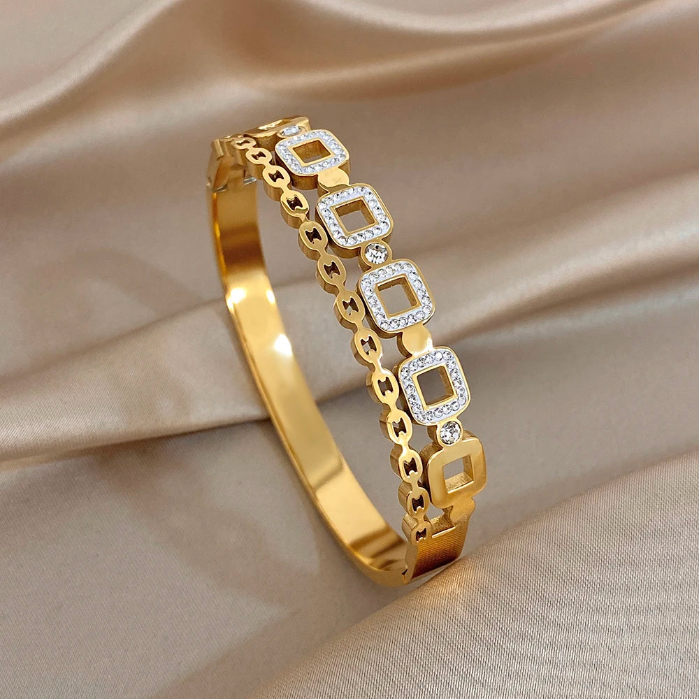 Gold-plated openwork cuff bangle with square zircon frames and linked design
