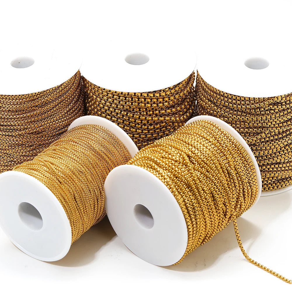 Gold rolo box chain spools, neatly wound on white reels