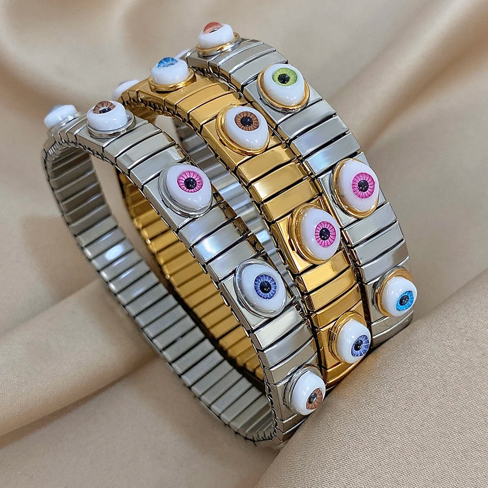 Stainless steel elastic bracelet with alternating gold and silver links and multicolor evil eye tiles