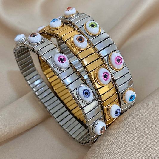Stainless steel elastic bracelet with alternating gold and silver links and multicolor evil eye tiles