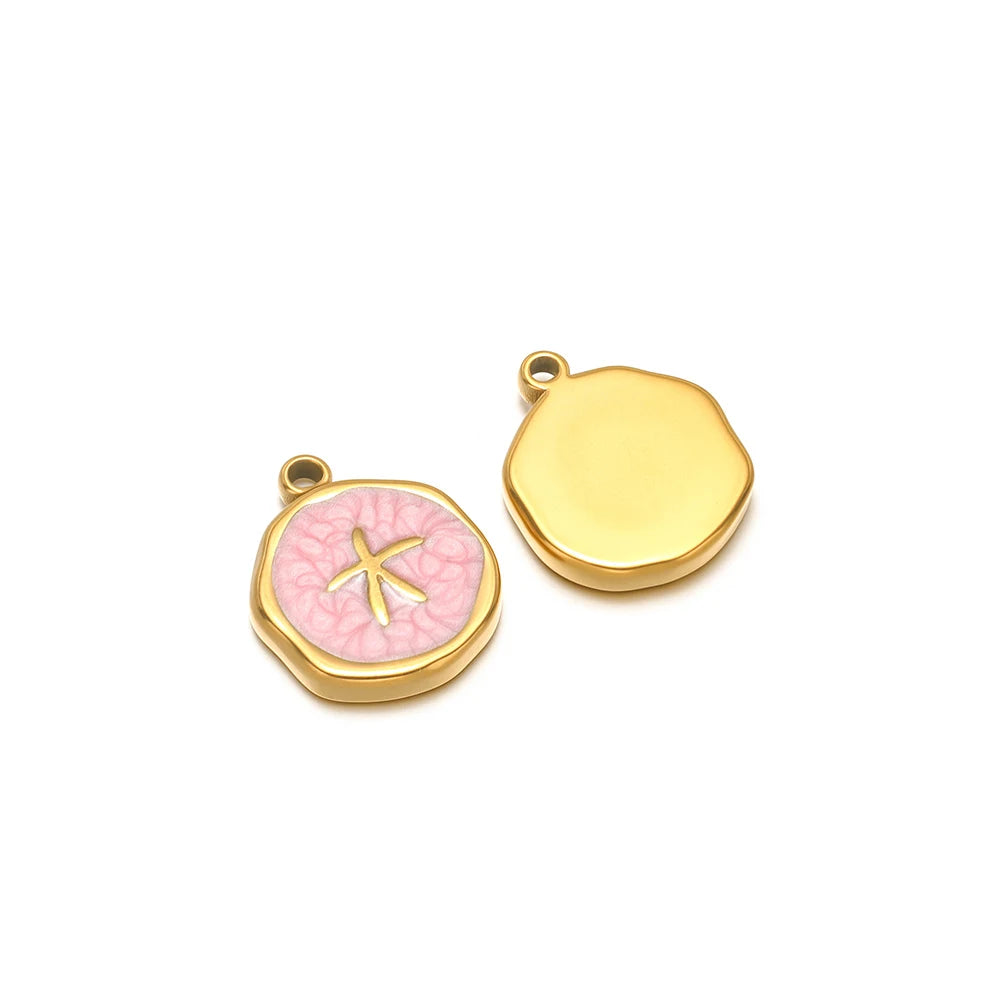 Enamel shell charm pendants, one pink with gold star fish design and one yellow plain cap