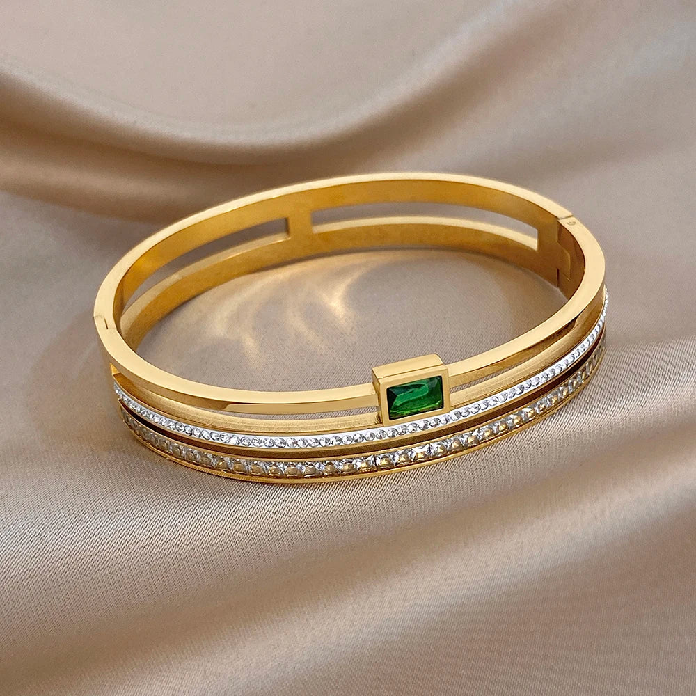 Gold-plated stainless steel cuff bracelet with green stone and clear zircon accents