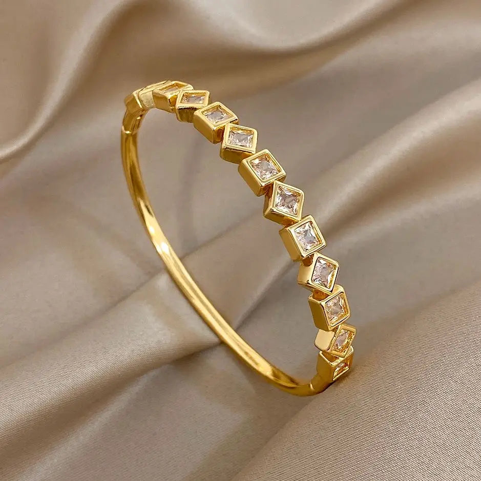 Gold-tone geometric zircon cuff bracelet with square clear stones in a row