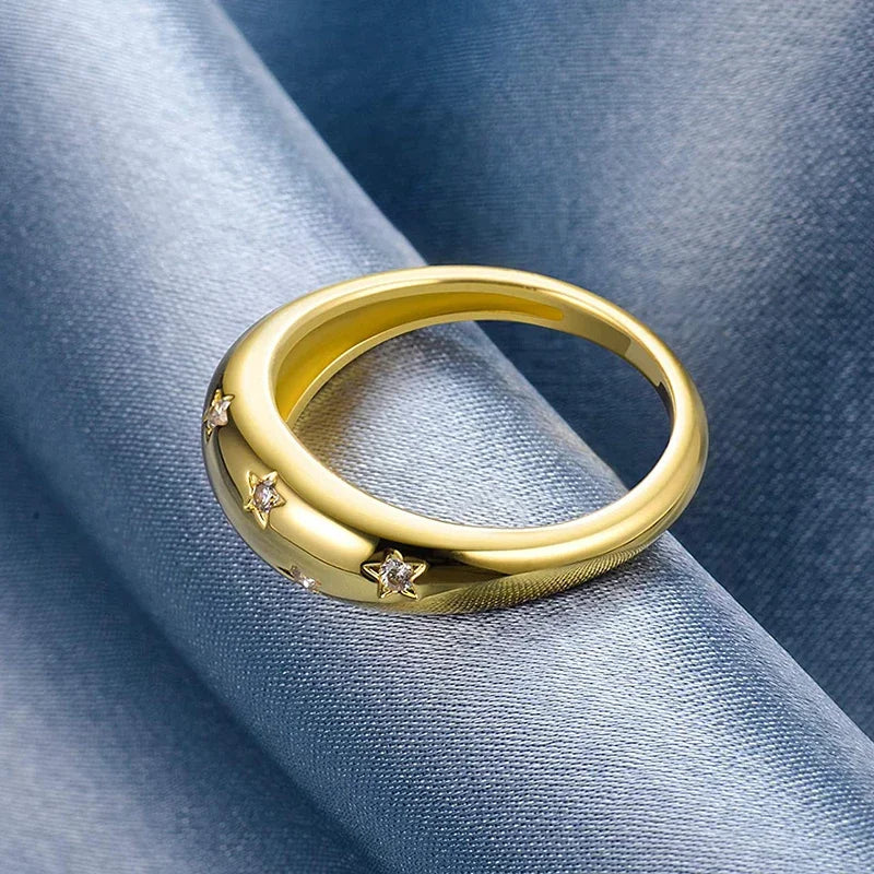 Gold-tone wedding band ring with star inlays and sparkle stones, side view