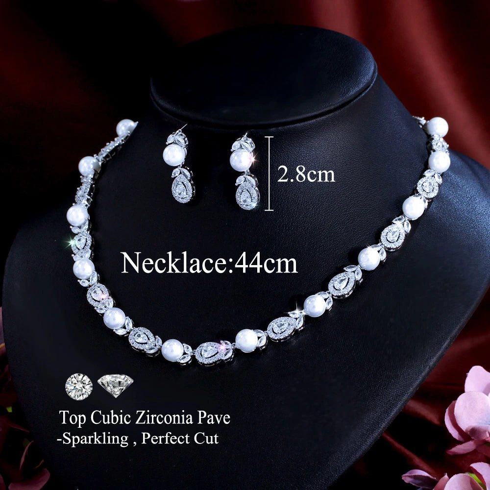 Cubic zirconia and pearl bead necklace set with teardrop drop earrings on jewelry stand