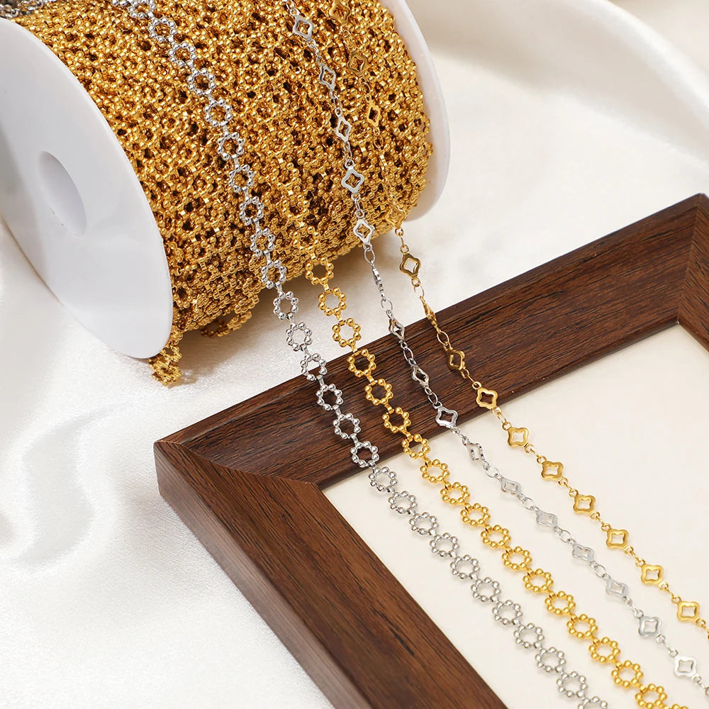 Square-link chain strands in gold and silver tones laid over wooden display block