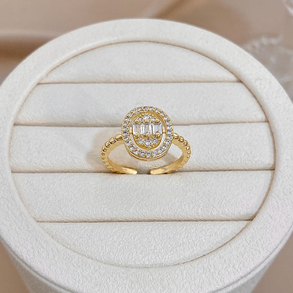 Gold-plated round zircon cluster ring with halo design on display